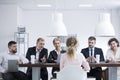 Group of recruiters interviewing woman