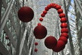 A group of red balls is installed as street artwork on the atrium of an office building