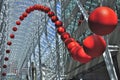 A group of red balls is installed on the atrium as street artwork