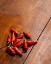 Group of red chili stack on top of each other in wooden table with empty negative spaces Royalty Free Stock Photo