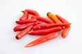 Group of red chilli peppers without stem on white background - top view, closed up