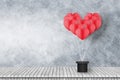 group of red heart shaped balloons float on cement wall with wooden floor Royalty Free Stock Photo