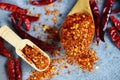 Group of red hot chilli powder on black plate top view ingredients table asian food spicy in thailand - cayenne pepper on wooden Royalty Free Stock Photo