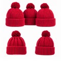 Group of Red Knitted Beanie Hats with Pom Poms on White Background Royalty Free Stock Photo