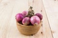 Group of red onion in the wood bowl. Royalty Free Stock Photo