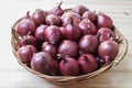 Group of red onions in a wicker basket. Royalty Free Stock Photo