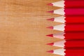Group red pencil on wooden table