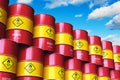 Group of red stacked oil drums against blue sky with clouds Royalty Free Stock Photo