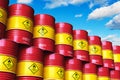 Group of red stacked oil drums against blue sky with clouds Royalty Free Stock Photo