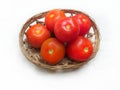 Group of red tomatoes in rattan woven basket
