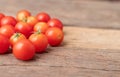 Group red tomatoes on the wooden table