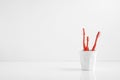 Group of red toothbrush in a plastic cup with a blank space for a text Royalty Free Stock Photo