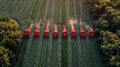 Group of Red Tractors Driving Through Green Field Royalty Free Stock Photo