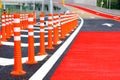 Group of red traffic cones installed on new road warning sign for safety drive