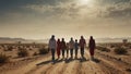 group of refugees, including children and women, walk along a dusty desert road