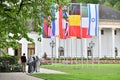 A group of refugees from the Middle East, three women in hijabs and a man walking through the park in Europe, against the