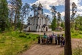 Group of religious people staing in front of The Wight Stone Church in the forest.