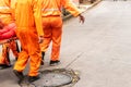 Group of rescuers in orange suit carrying a victim of natural disaster on a stretcher