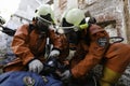 A group of rescuers provide first aid to the victim during the collapse of the building.