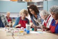 Group Of Retired Seniors Attending Art Class In Community Centre With Teacher Royalty Free Stock Photo