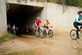 Group of riders exiting a tunnel