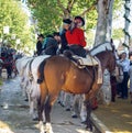 Group of riders on horseback enjoy April Fair, Seville Fair Feria de Sevilla. Royalty Free Stock Photo