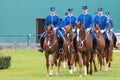 A group of riders from the mounted guard entering the arena