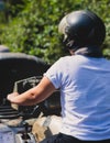 Group of riders riding ATV vehicle crossing forest rural road, process of driving rental vehicle, all terrain quad bike vehicle, Royalty Free Stock Photo