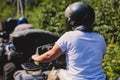 Group of riders riding ATV vehicle crossing forest rural road, process of driving rental vehicle, all terrain quad bike vehicle, Royalty Free Stock Photo