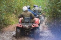 Group of riders riding atv vehicle on off road track, process of driving ATV vehicle, all terrain quad bike vehicle, during Royalty Free Stock Photo