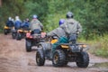 Group of riders riding atv vehicle on off road track, process of driving ATV vehicle, all terrain quad bike vehicle, during Royalty Free Stock Photo