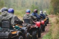 Group of riders riding atv vehicle on off road track, process of driving ATV vehicle, all terrain quad bike vehicle, during Royalty Free Stock Photo