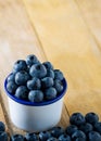 Group of blueberries in the cup on table fruit background Royalty Free Stock Photo