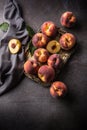 A group a ripe peaches in rustic bowl