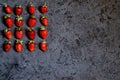 Group of ripe red strawberries in a shape of a square in the upper left corner on dark background. Strawberry pattern. Dark low Royalty Free Stock Photo