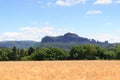 Group of rocks Schrammsteine and Falkenstein with grain field in Saxon Switzerland