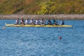 Group of rowing team athletes sculling during competition, kayak boats race in a rowing canal, regatta in a summer sunny day,