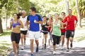 Group Of Runners Jogging Through Park Royalty Free Stock Photo