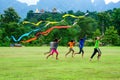 Group of rural children playing kite together on field Royalty Free Stock Photo