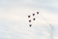 group of Russian military aircraft shows aerobatics in the blue sky against the background of clouds Royalty Free Stock Photo