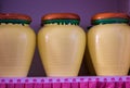 Group of rustic ceramic yellow kitchen canisters on gray background