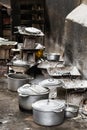 Rustic charcoal stoves and cookware, pots and pans on the floor at the local market of Toliara, Madagascar