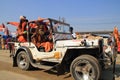 A group of Sadhus travel in an open vehicle at Kumbh Mela