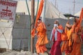 A group of Sadhus wearing orange attire walking on the pilgrim route to holy Ganges and Sangam.