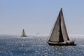 Sloop sailboat on a quiet sea in open waters. Royalty Free Stock Photo