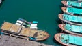 Group of sailing boats anchoring in marina next to jetty wooden pier. Aerial photo, high angle of view, bird eye