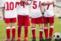 Group of School Boys in Sports Team. Boys Huddling on aPitch Side Line During Tournament Game.