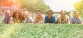 Group of school children resting on grass and smiling Royalty Free Stock Photo