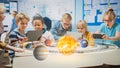 Group of School Children in Science Class Use Digital Tablet Computers with Augmented Reality
