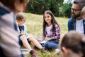 Group of school children with teacher on field trip in nature, learning science. Royalty Free Stock Photo